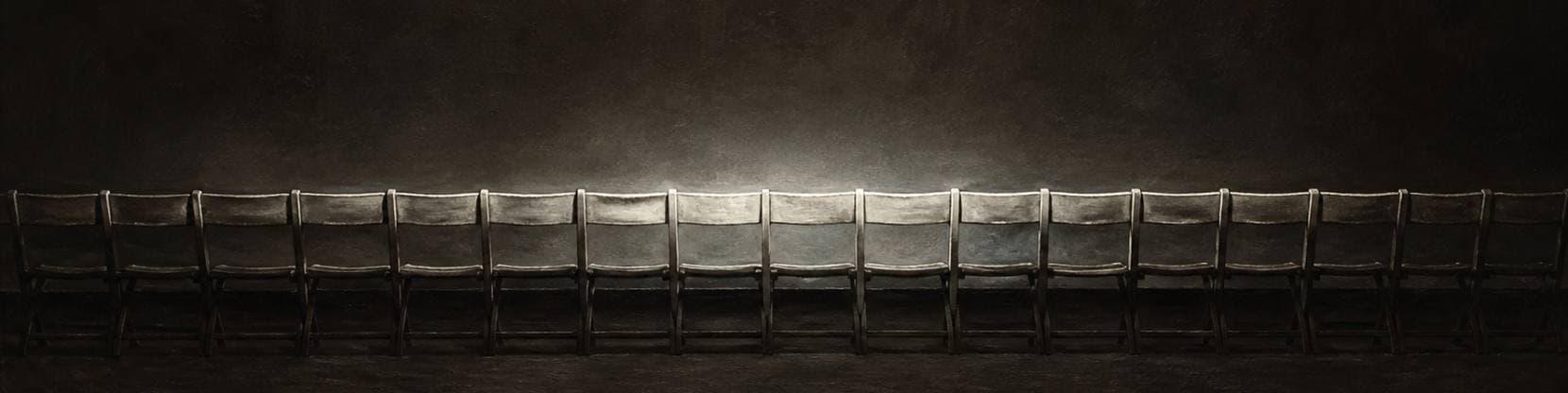 Painting of a long row of empty wooden folding chairs standing in a darkened hall, lit by a single cool wash of light.