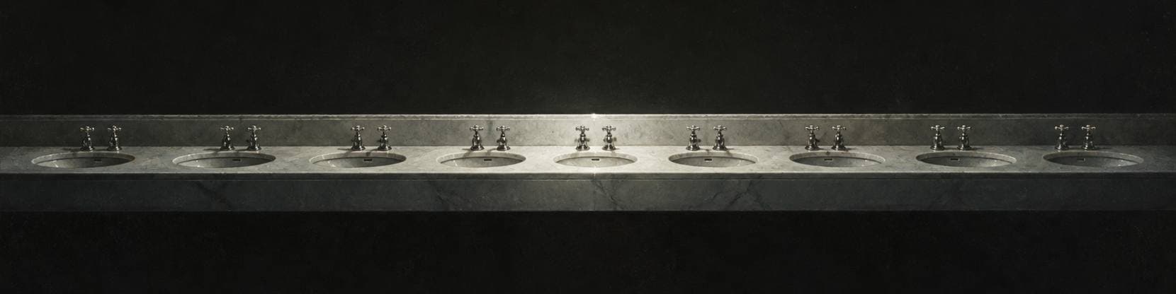 Painting of a long marble washstand with a row of basins and polished taps, lit by cold silver light in a dark room.